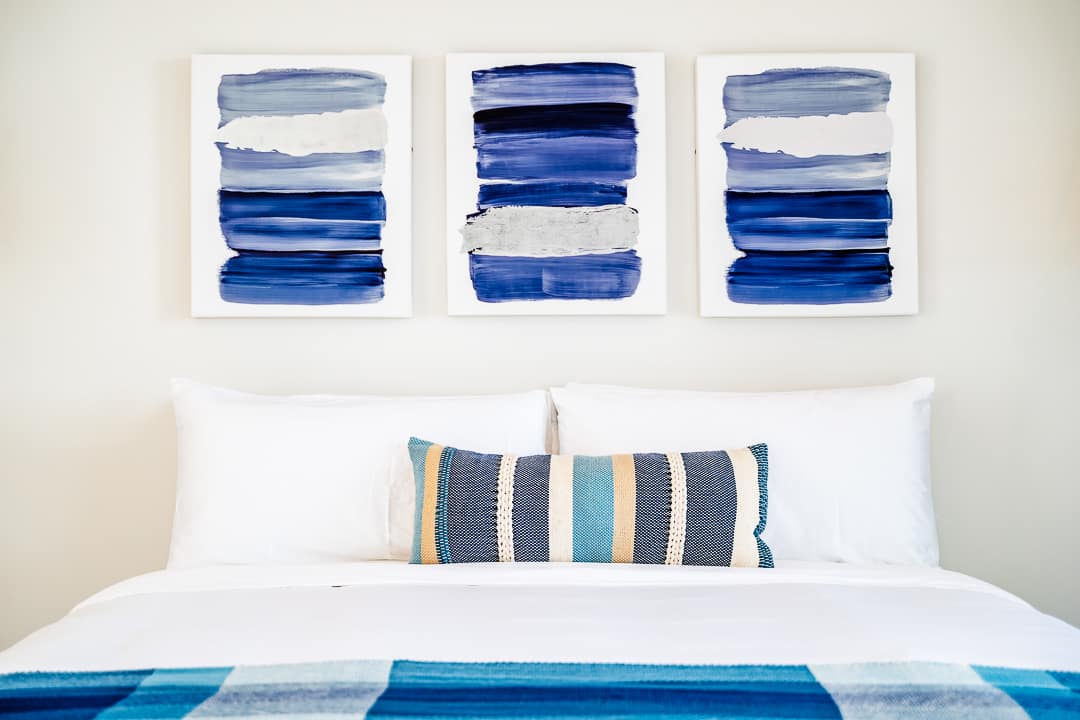 Luxury bedroom with floor-to-ceiling windows overlooking lush greenery and ocean views at the Reserva Conchal penthouse in Costa Rica