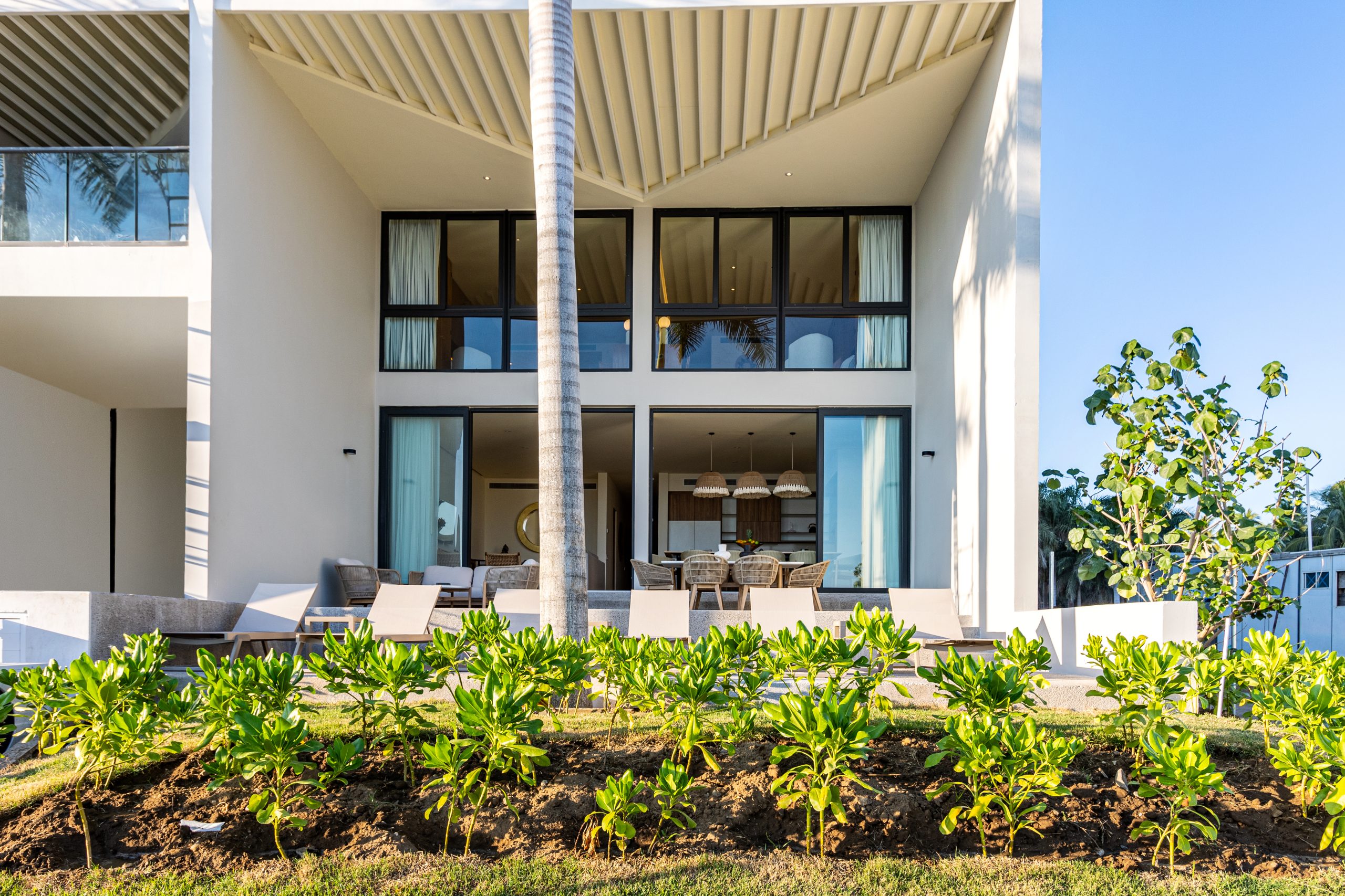 Modern luxury villa in Nuevo Vallarta, Mexico featuring contemporary architecture, private pool, and tropical garden views near the beach.