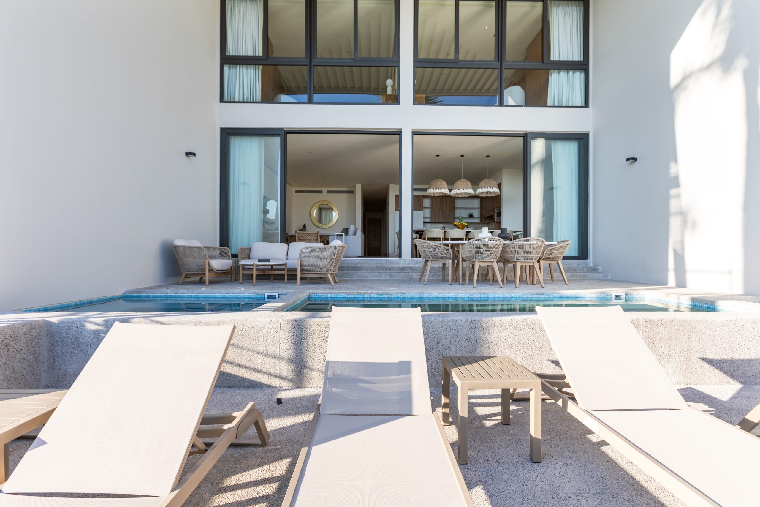 Modern luxury villa in Nuevo Vallarta, Mexico featuring contemporary architecture, private pool, and tropical garden views near the beach.