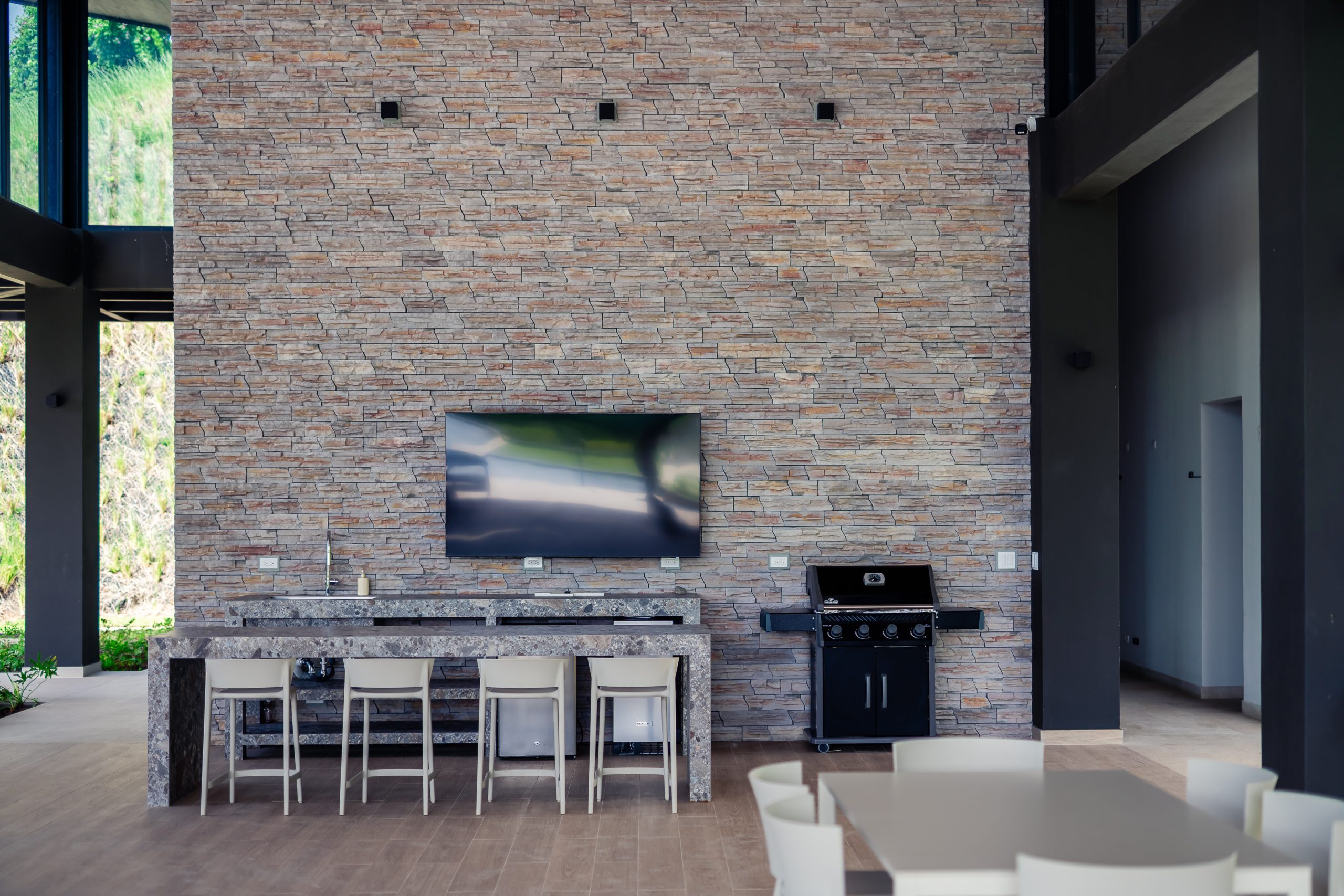 Modern clubhouse at Reserva Conchal surrounded by tropical gardens and coastal scenery.