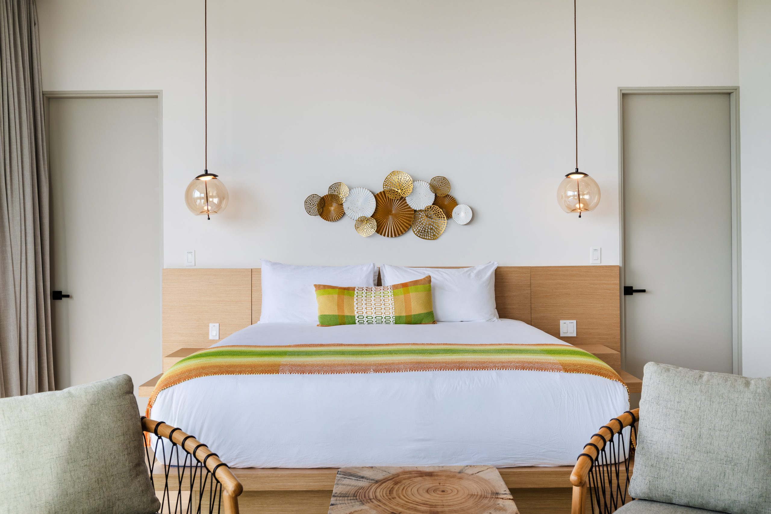 Luxury bedroom with floor-to-ceiling windows overlooking lush greenery and ocean views at the Reserva Conchal penthouse in Costa Rica