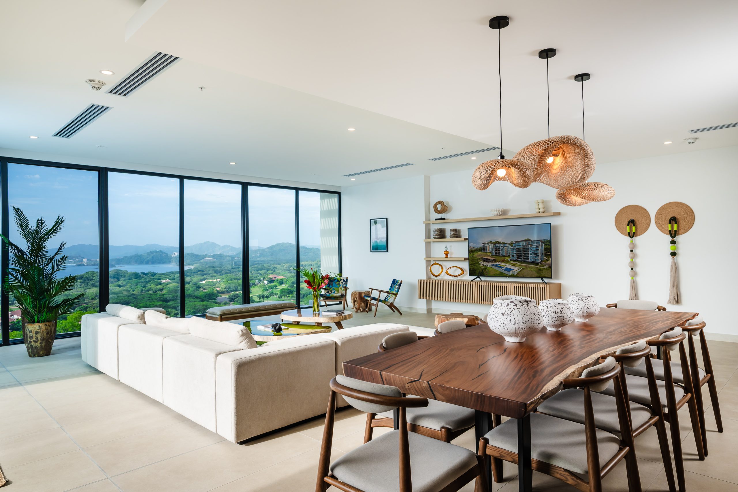Spacious dining and living area inside the Reserva Conchal penthouse, featuring modern furnishings, open-concept design, and views of Costa Rica’s tropical landscape.