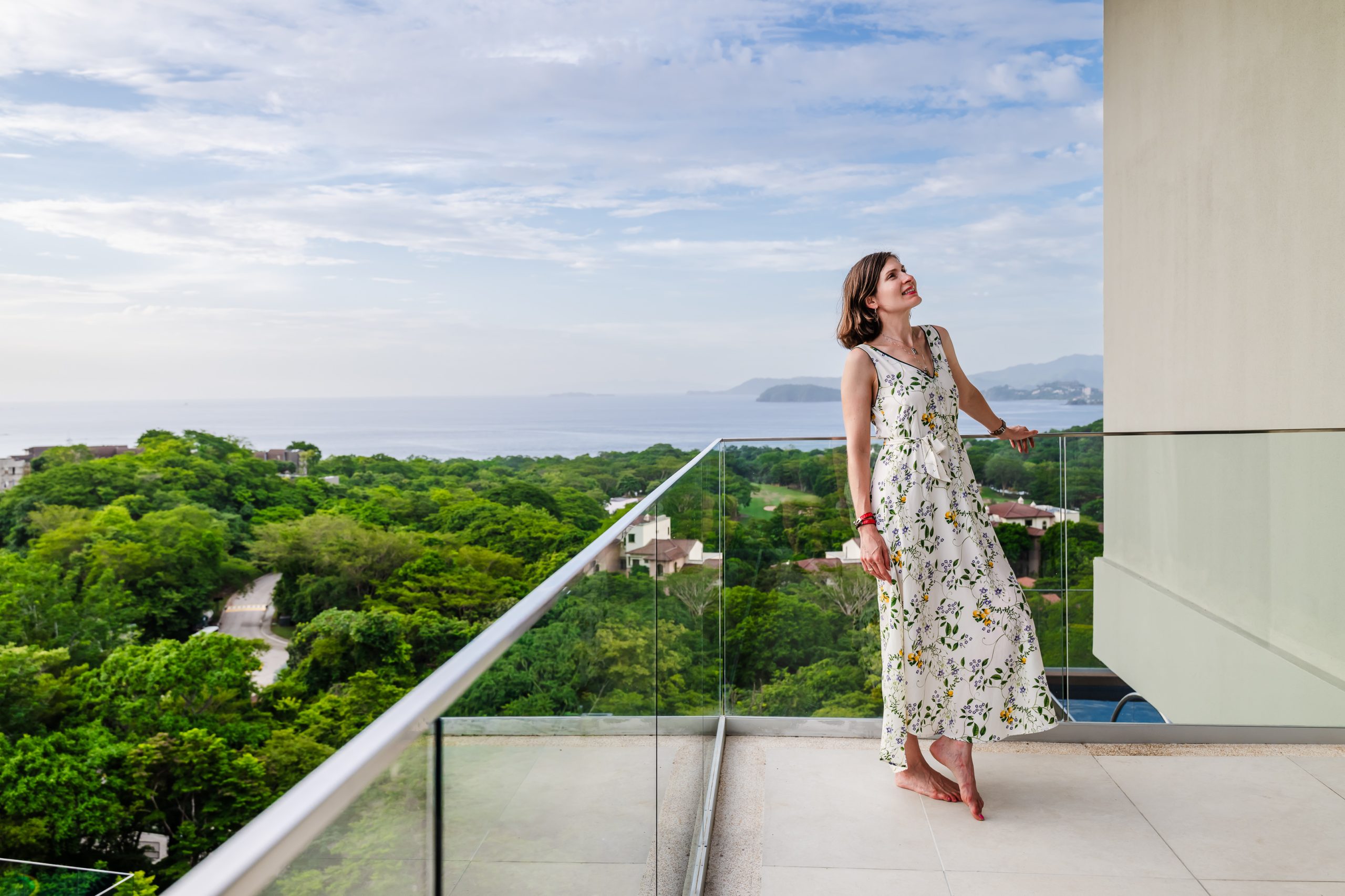 Marina Salley, Head of Investor Relations, relaxing on the terrace of the Reserva Conchal penthouse, enjoying panoramic views of Costa Rica’s coastline and tropical scenery.