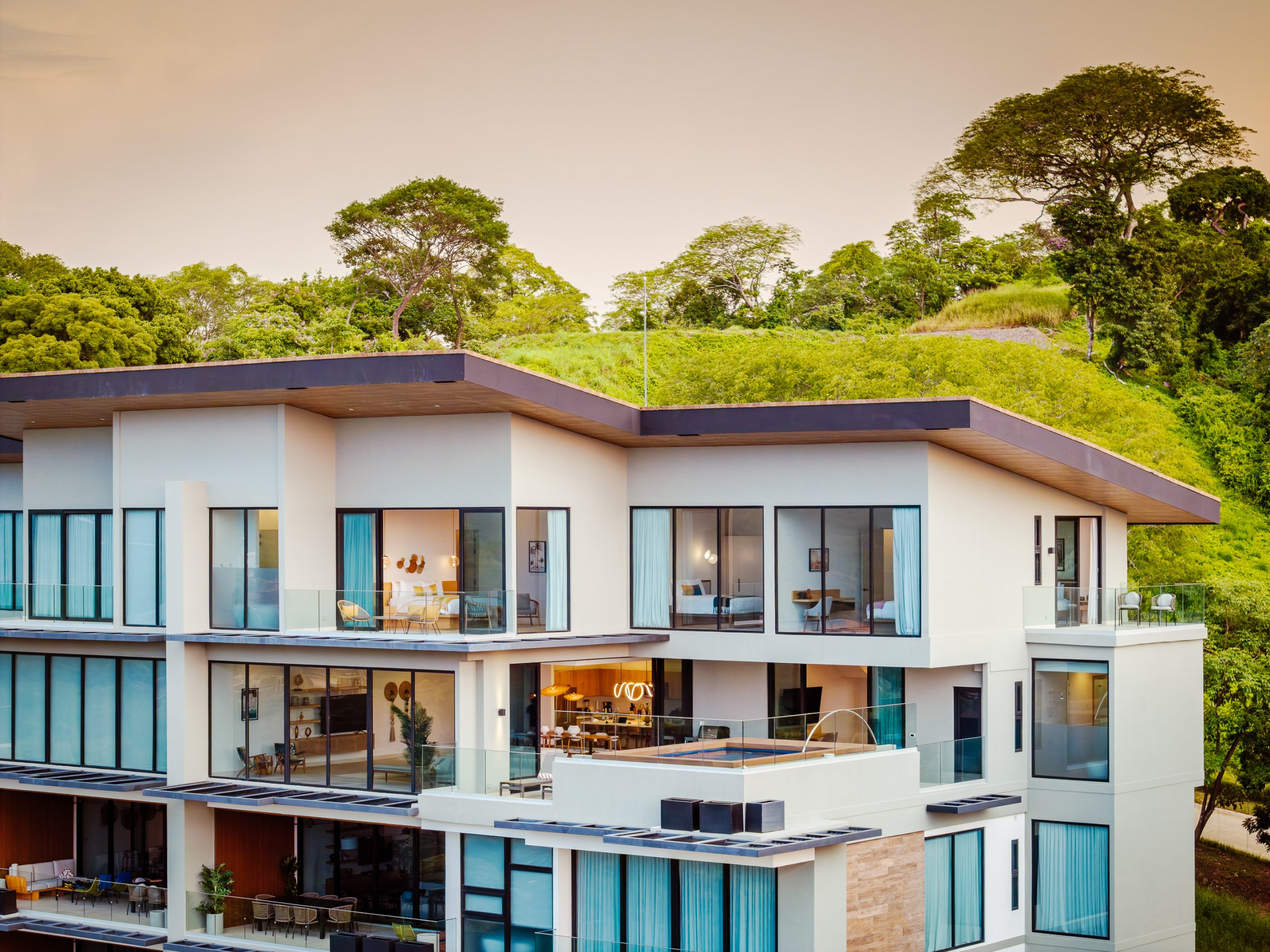 Modern ocean-view penthouse at Reserva Conchal, featuring floor-to-ceiling windows and a private infinity pool overlooking Costa Rica’s lush tropical hillsides.