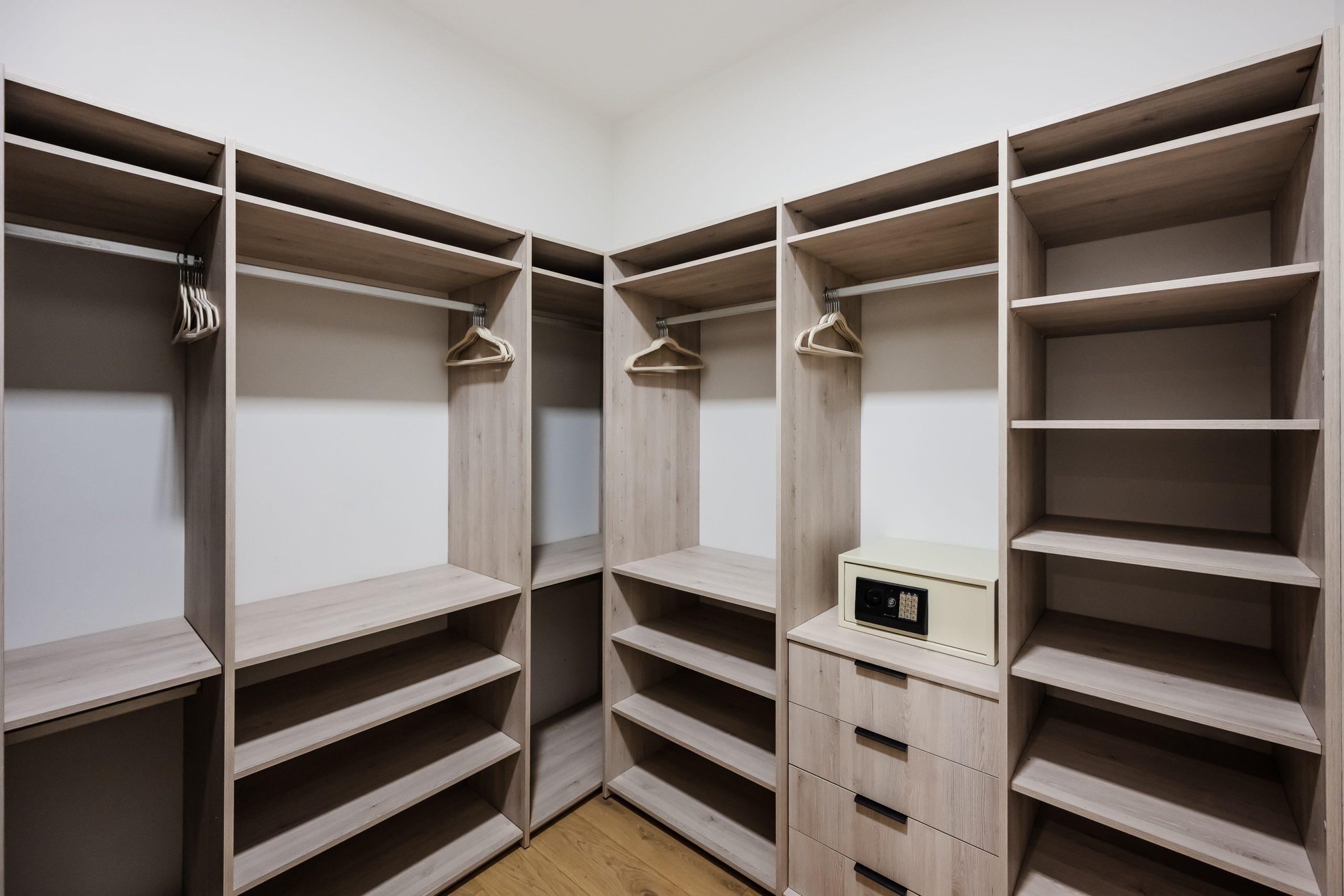 Spacious walk-in closet with built-in storage and a safe inside the Reserva Conchal penthouse, offering elegant design and modern convenience.