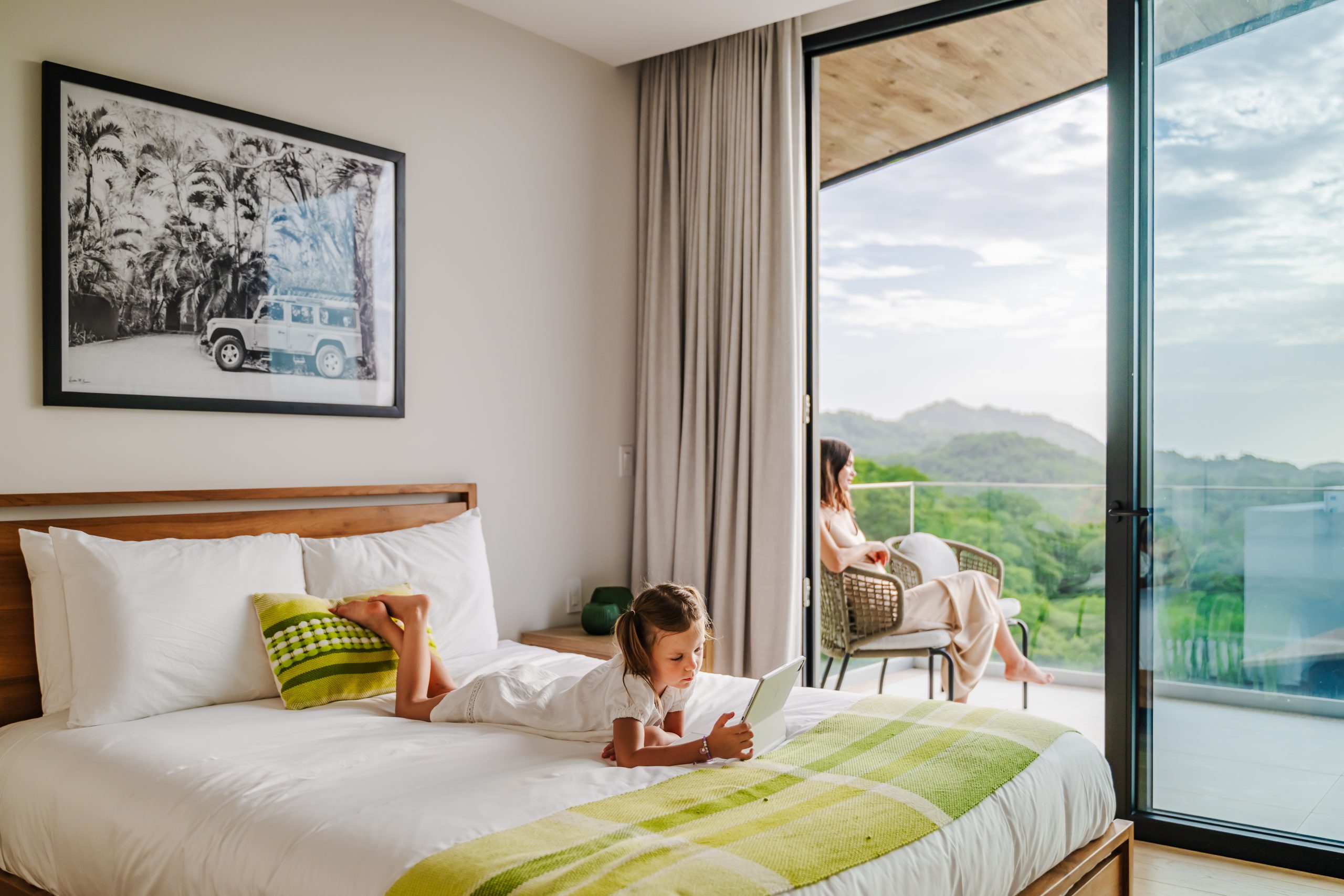 Mother and daughter relaxing in a Reserva Conchal penthouse with ocean and jungle views in Costa Rica.