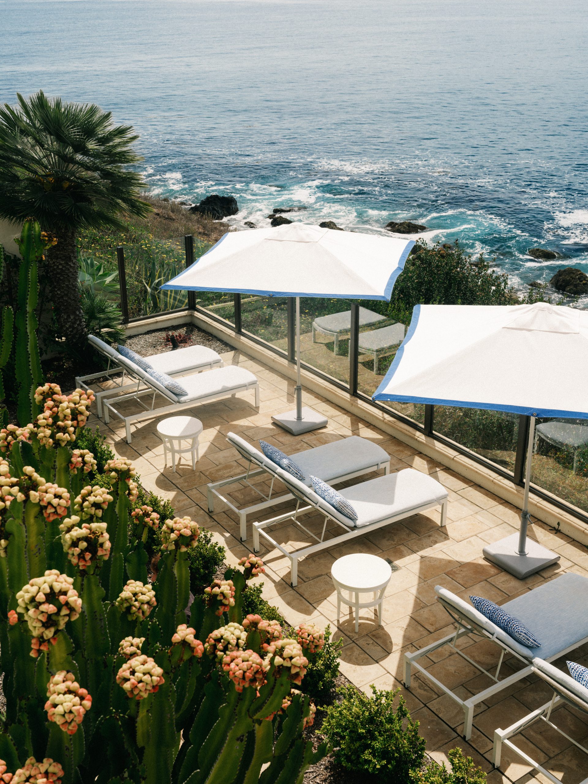 Oceanfront spa terrace at Terranea Resort with lounge chairs, umbrellas, and views of the Pacific Ocean.